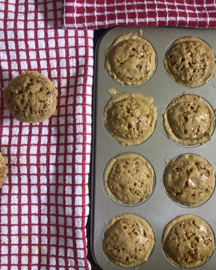 Golden-brown Sri Lankan cheesecake tarts in a 12-cup muffin tin, with two tarts on a red checked cloth