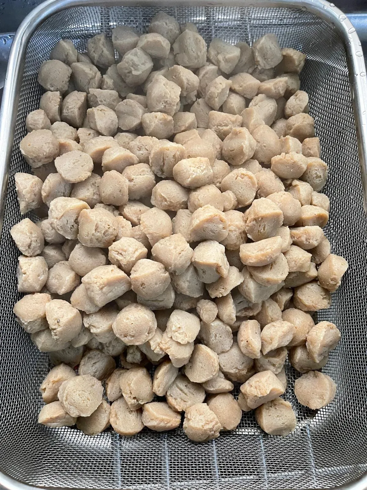 Step 2: Strain the soy meat in a colander and press with a spoon to remove excess water.