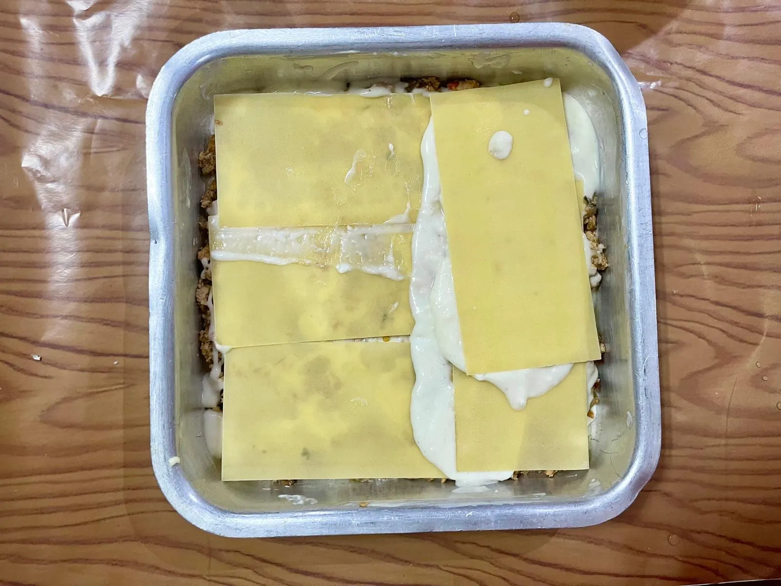 Step 6, photo 2: Continue layering the lasagna sheets, sauce, and meat filling until the dish is nearly ful