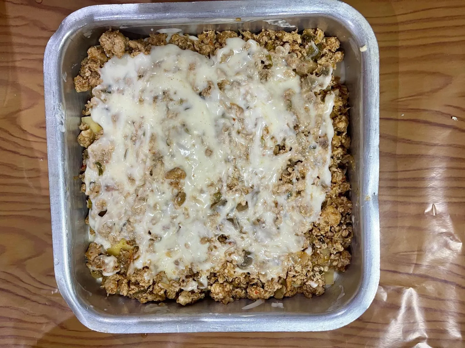 Step 6, photo 3: Continue layering the lasagna sheets, sauce, and meat filling until the dish is nearly ful