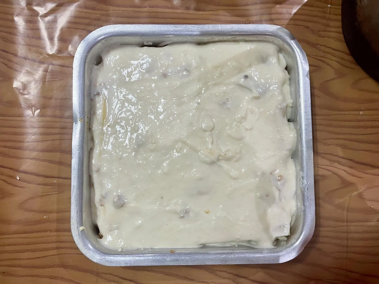 Step 7, photo 2: Finish with a final layer of lasagna sheets. Pour the remaining lasagna sauce evenly over 
